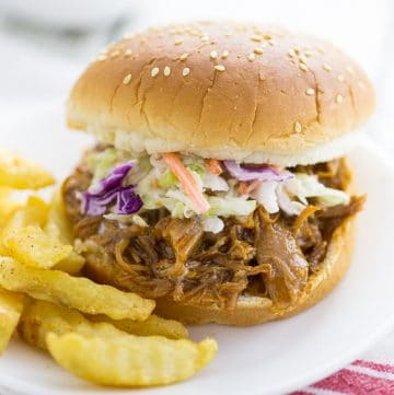 Easy Crock Pot Barbecue Pulled Pork Recipe - Super easy, 3 ingredient Crock Pot Barbecue Pulled Pork is the perfect hands-off dinner for a busy day that everyone will love! Just grab buns at dinner time and you're ready to go!
