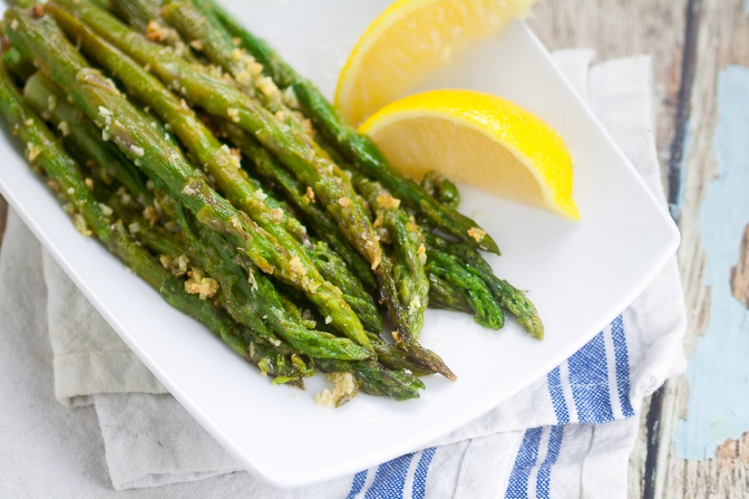 Oven Roasted Asparagus recipe - Oven Roasted Asparagus is a simple side dish that takes just minutes to prep. With garlic and Parmesan cheese, it's all fresh flavor and no hassle!  Super easy side dish recipe that's super delicious too. 