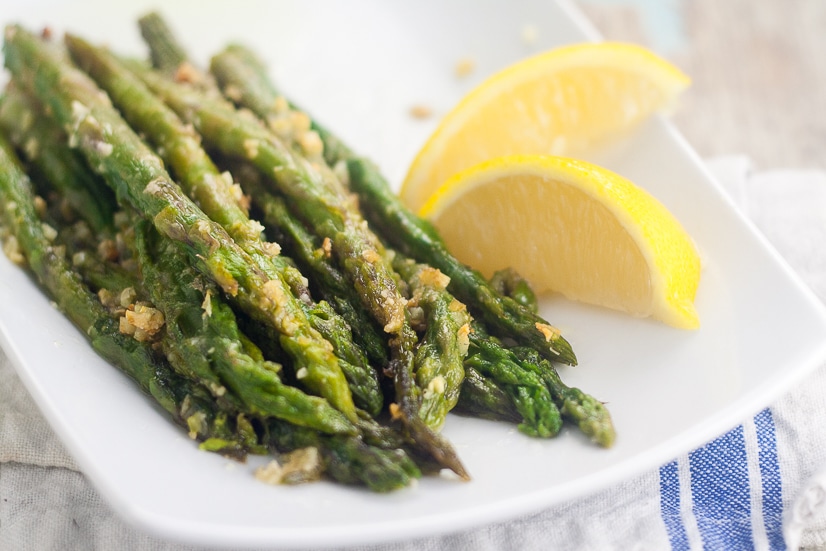 Oven Roasted Asparagus recipe - Oven Roasted Asparagus is a simple side dish that takes just minutes to prep. With garlic and Parmesan cheese, it's all fresh flavor and no hassle!  Super easy side dish recipe that's super delicious too. 