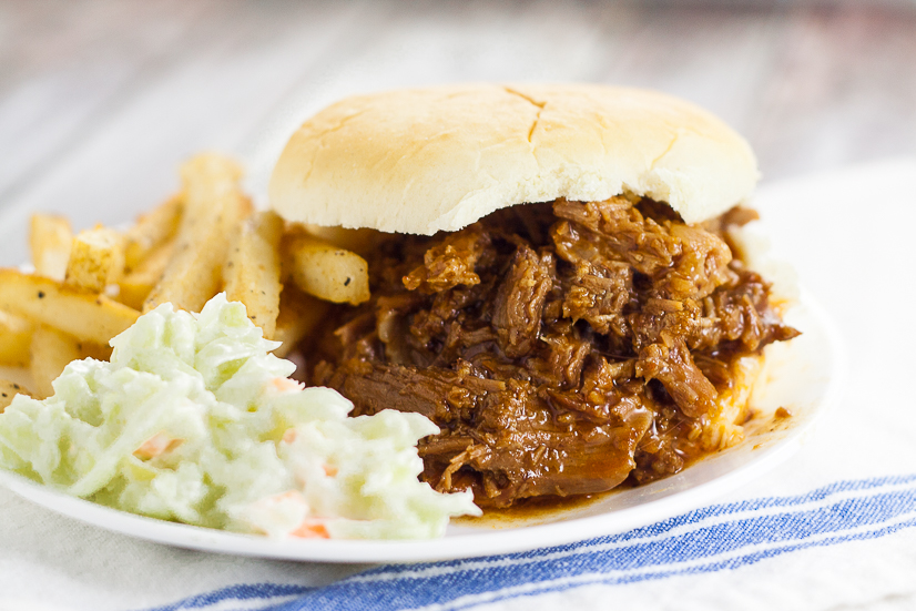 Crock Pot Root Beer Pulled Beef Sandwiches recipe - A 5 ingredient fix-it-and-forget-it slow cooker dinner, this Crock Pot Root Beer Pulled Beef recipe has the perfect combination of tangy sweetness and takes just minutes to throw together! Easy slow cooker recipe perfect for family