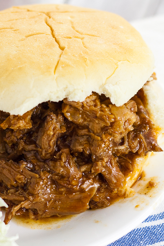 Crock Pot Root Beer Pulled Beef Sandwiches recipe - A 5 ingredient fix-it-and-forget-it slow cooker dinner, this Crock Pot Root Beer Pulled Beef recipe has the perfect combination of tangy sweetness and takes just minutes to throw together! Easy slow cooker recipe perfect for family