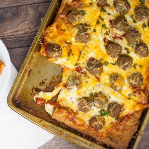 Meatball Pizza Recipe - A quick and easy recipe for Meatball Pizza that even the kids can help with! Crispy crust, gooey cheese, and Italian meatballs make the perfect family pizza night! Quick and easy family dinner recipe the kids will LOVE!