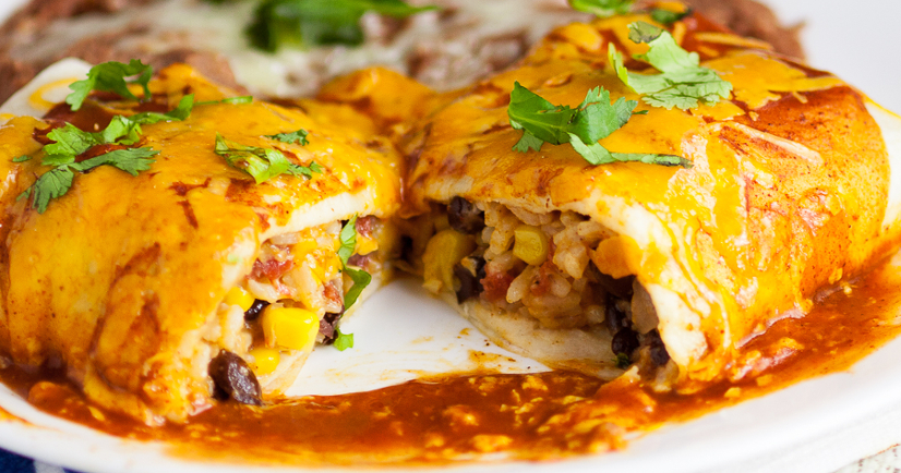 Rice and Black Bean Burritos Recipe - Quick and easy Mexican-inspired dinner recipe, these Rice and Black Bean Burritos are filled with flavorful rice and beans and smothered in enchilada sauce and cheese for a yummy vegetarian dinner perfect for Meatless Monday.