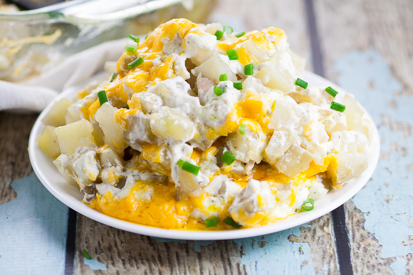 Cheesy Ranch Potatoes Recipe - Creamy, Cheesy Ranch Potatoes are the ultimate comfort food recipe that everyone will love.  Perfect for potlucks, holidays, and a crowd favorite dish to pass. Soft, warm potatoes covered in creamy ranch and cream cheese and topped with gooey melted cheddar.  Easy potato side dish recipe. 