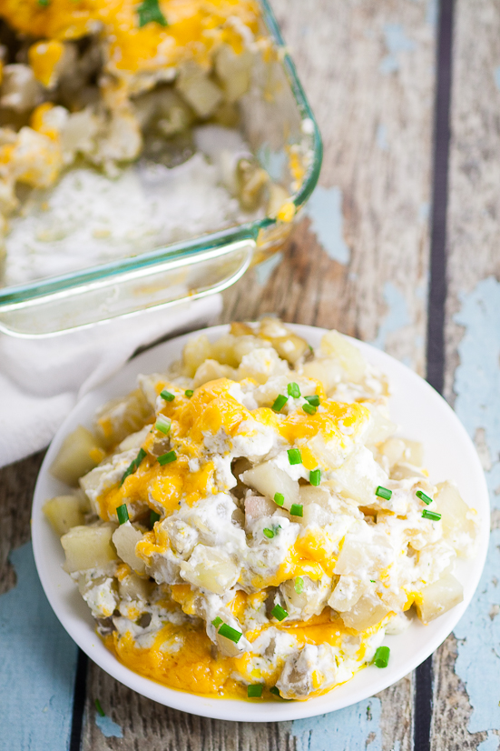 Cheesy Ranch Potatoes Recipe - Creamy, Cheesy Ranch Potatoes are the ultimate comfort food recipe that everyone will love.  Perfect for potlucks, holidays, and a crowd favorite dish to pass. Soft, warm potatoes covered in creamy ranch and cream cheese and topped with gooey melted cheddar.  Easy potato side dish recipe. 