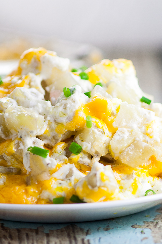 Cheesy Ranch Potatoes Recipe - Creamy, Cheesy Ranch Potatoes are the ultimate comfort food recipe that everyone will love.  Perfect for potlucks, holidays, and a crowd favorite dish to pass. Soft, warm potatoes covered in creamy ranch and cream cheese and topped with gooey melted cheddar.  Easy potato side dish recipe. 