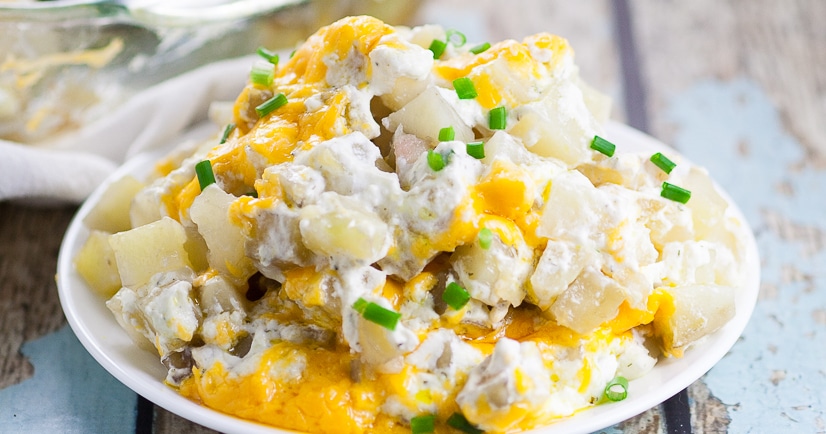 Cheesy Ranch Potatoes Recipe - Creamy, Cheesy Ranch Potatoes are the ultimate comfort food recipe that everyone will love.  Perfect for potlucks, holidays, and a crowd favorite dish to pass. Soft, warm potatoes covered in creamy ranch and cream cheese and topped with gooey melted cheddar.  Easy potato side dish recipe. 