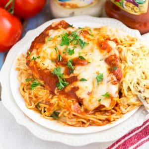 One Dish Baked Cheesy Chicken and Pasta Recipe - One Dish Baked Cheesy Chicken and Pasta with a creamy tomato marinara pasta, spinach, mozzarella, and Parmesan topped with juicy chicken breast.  Mix it all together and bake for a simple, easy and delicious one dish meal!