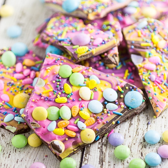 Chocolate Easter Bark is a simple, festive, spring treat featuring two kinds of chocolate swirled together and topped with M&M's, chocolate eggs, and sprinkles! The pastel colors, fun sprinkles, and candy make this a super fun and festive no bake Easter treat for kids!