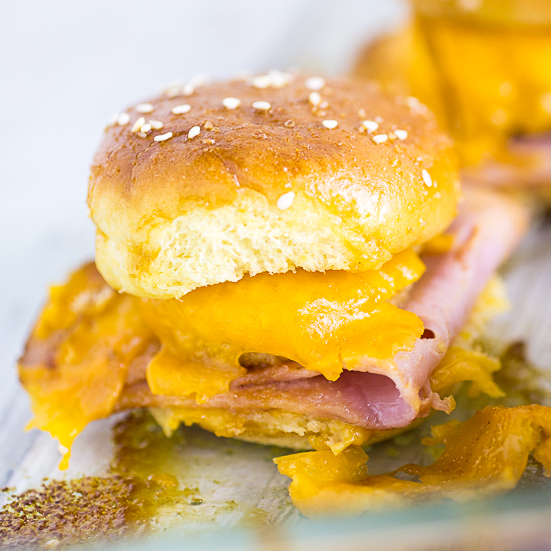 Warm and gooey Ham and Pimento Cheese Sliders take just 5 minutes to prep! Buttery sweet buns, salty ham, creamy and zesty Pimento Cheese Bites make a flavorful explosion in your mouth.  Dip them in the sweet and tangy Red Pepper Jelly sauce to take them from great to drool-worthy. These sliders make an amazing quick and easy snack or easy appetizer. So. Good.