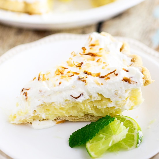 This old-fashioned Coconut Cream Pie recipe features creamy, silky homemade custard with sweet coconut flakes folded in a flaky pie crust topped with some fluffy homemade whipped cream and some toasted coconut flakes to make it pretty.  I really love the flavors in this pie and it's cool, creamy filling make it a perfect spring dessert that we now serve as an Easter dessert every year!