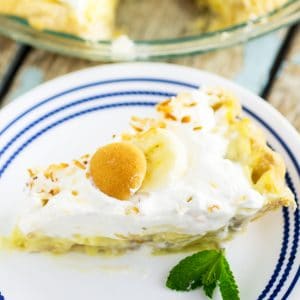 This light and fluffy Banana Cream Pie recipe with pudding is loaded with fresh bananas and silky filling, then topped with piles of  homemade whipped cream and toasted coconut. The end result of this homemade old-fashioned banana cream pie is beyond words. The banana lovers you bake it for will be in pie heaven.