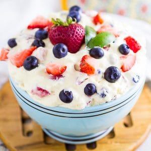 This simple Berry Cheesecake Salad recipe is quick and easy to make! Rich and creamy cheesecake filling is folded into your favorite berries to create the most amazing fruit salad ever! Your family will go nuts over it.