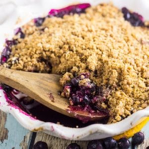 This stunning summer fruit crumble has it all! Blueberry Peach Crumble is bursting with fresh blueberries and peaches and covered with an amazing buttery cinnamon and brown sugar oatmeal crumble for a tangy, sweet, and fresh dessert. A big scoop of cold creamy vanilla ice cream on top is a must!