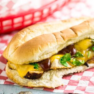 Tender, juicy, and zesty Grilled Barbecue Pork Tenderloin Sandwich features juicy grilled pork tenderloins smothered in barbecue sauce, topped with cheese and sauteed onions, all on a roll. 