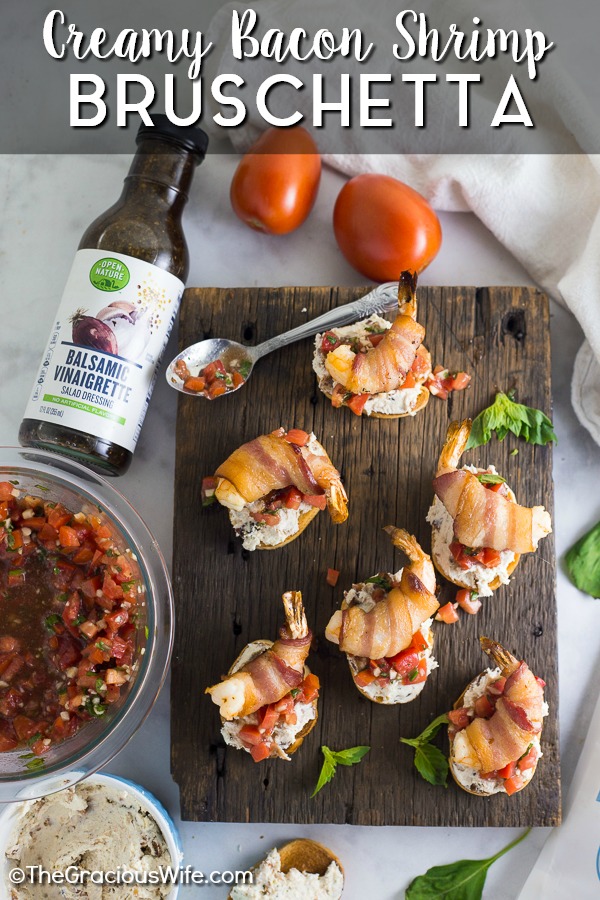 Creamy Bacon Shrimp Bruschetta recipe - Perfect appetizers for entertaining! This Creamy Bacon Shrimp Bruschetta recipe has it all with toasted baguette, a creamy garlic herb and bacon spread, balsamic vinaigrette, and THE BEST fresh basil and tomato bruschetta. Topped with a succulent bacon-wrapped shrimp! Make it for all your summer parties!