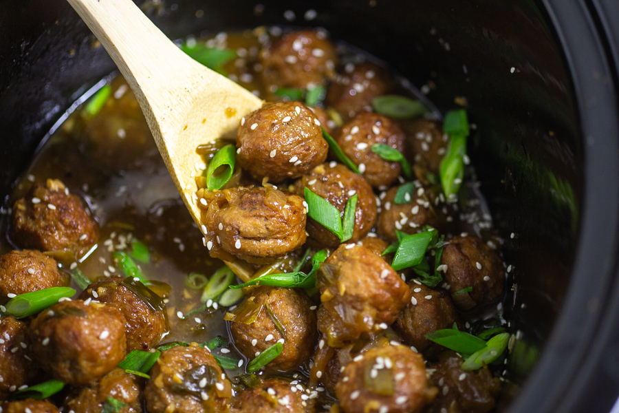 Slow Cooker Mongolian Meatballs are a super easy appetizer recipe featuring savory slow cooker meatballs in a sticky Mongolian glaze sauce.  This restaurant inspired recipe is a family favorite perfect for game day food, holiday appetizers for a crowd, or even served with rice for dinner.