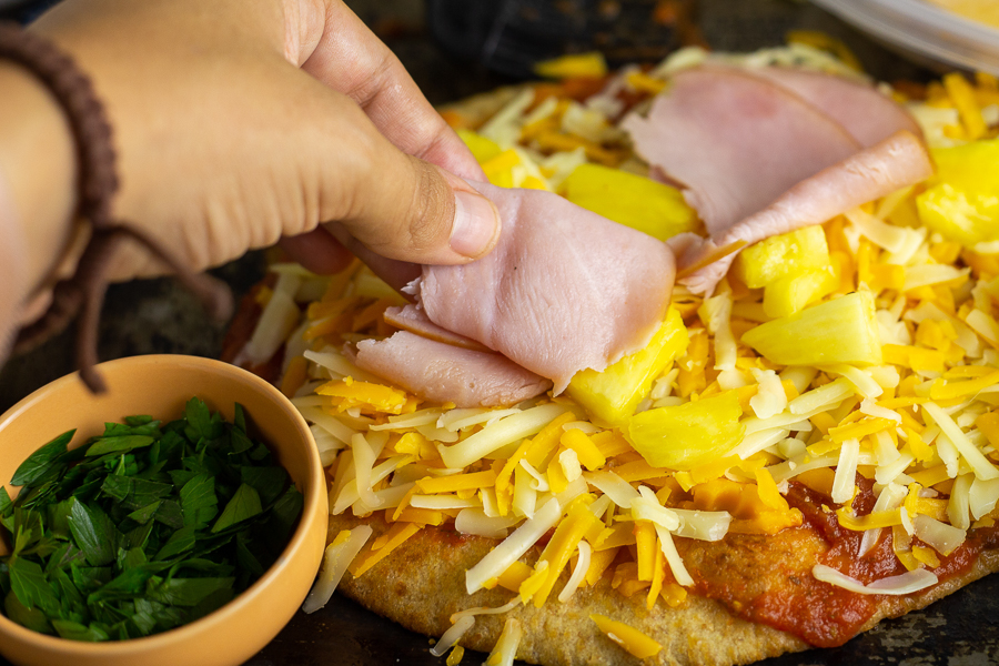 This Flatbread Hawaiian Pizza is quick, easy, and totally delicious! An addicting tangy, salty sweet combination with ham, pineapple, cheese, and a little bacon for good measure. 