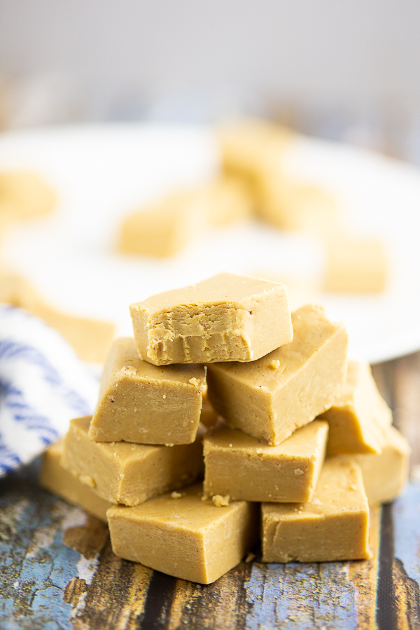 Stack of peanut butter fudge on a blue rustic wood background