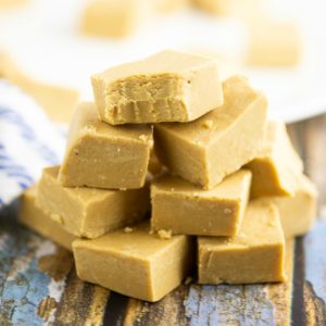 Stack of peanut butter fudge on a blue rustic wood background