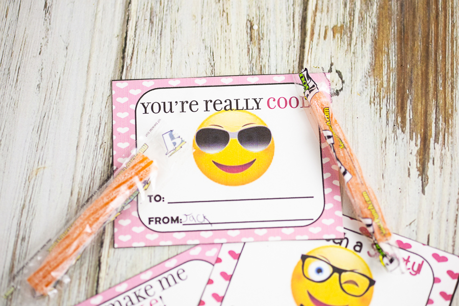 "You're Really" Cool emoji valentine on white wood background with orange sour straws