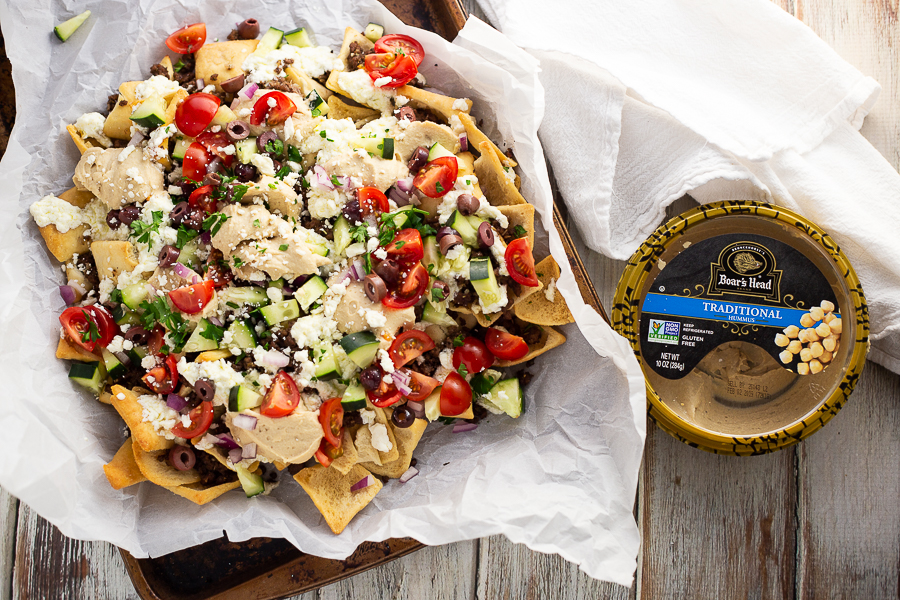 Greek Nachos on parchment paper on an old baking sheet