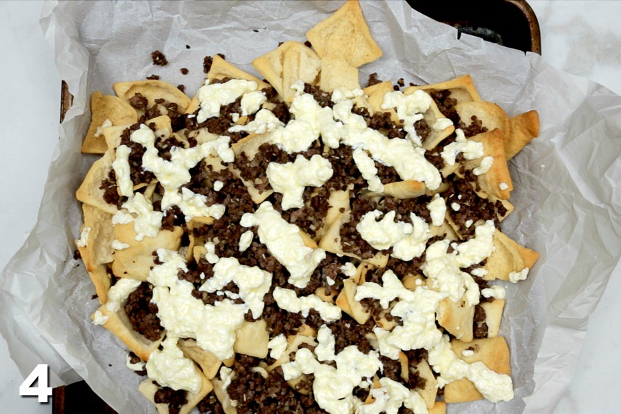 Feta cheese sauce and ground beef on pita chips