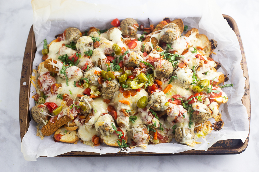 Baked Italian Nachos on a baking sheet on a white marble counter