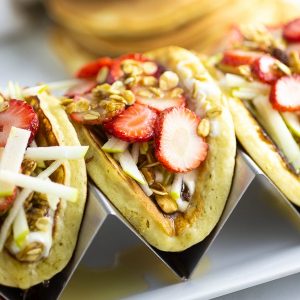 Pancake Parfait Tacos with fluffy pancakes filled with creamy yogurt, fresh fruit, crunchy granola, and a drizzle of honey. A quick and easy breakfast idea for kids that they'll love. I love that you can prep to make ahead, and throw together quickly in the morning, and even take on-the-go!