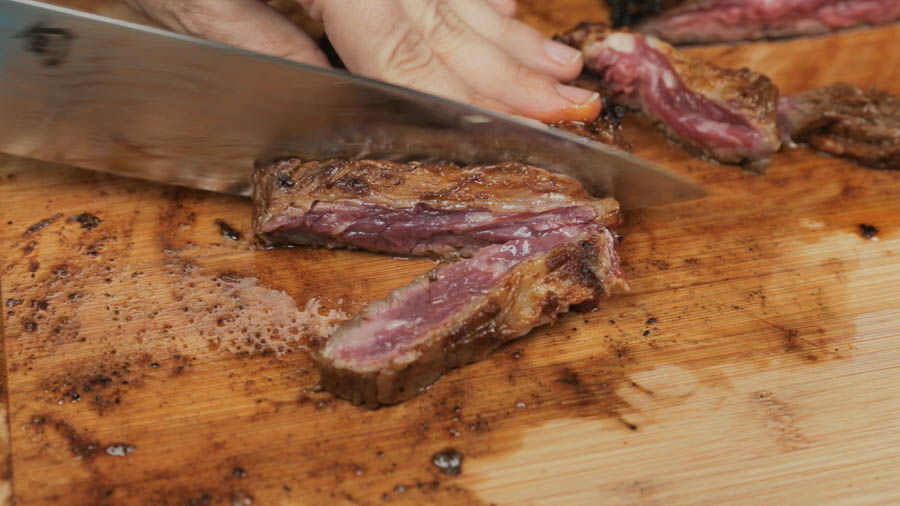 Cutting cooked skirt steak for fajitas