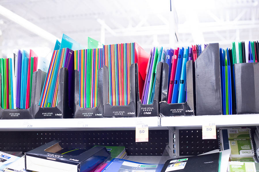 Row of colorful folders on Meijer store shelf