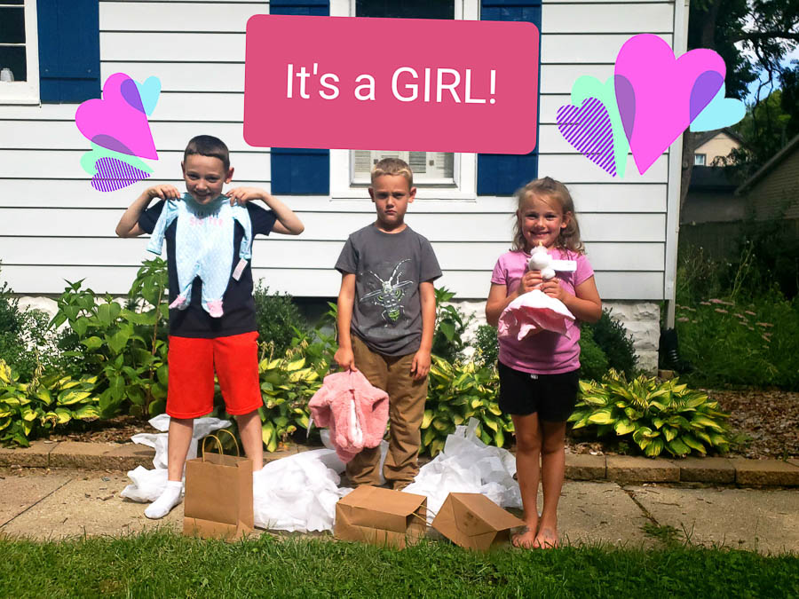 3 kids standing in front of a white house with brown bags