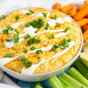 Best ever easy Crockpot Buffalo Chicken Dip is a creamy, cheesy crowd pleasing recipe with cool ranch and a spicy buffalo sauce kick. Tastes just like buffalo chicken wings, and will be the star of your party! Directions for cooking in the crock pot AND the oven! Plus video!