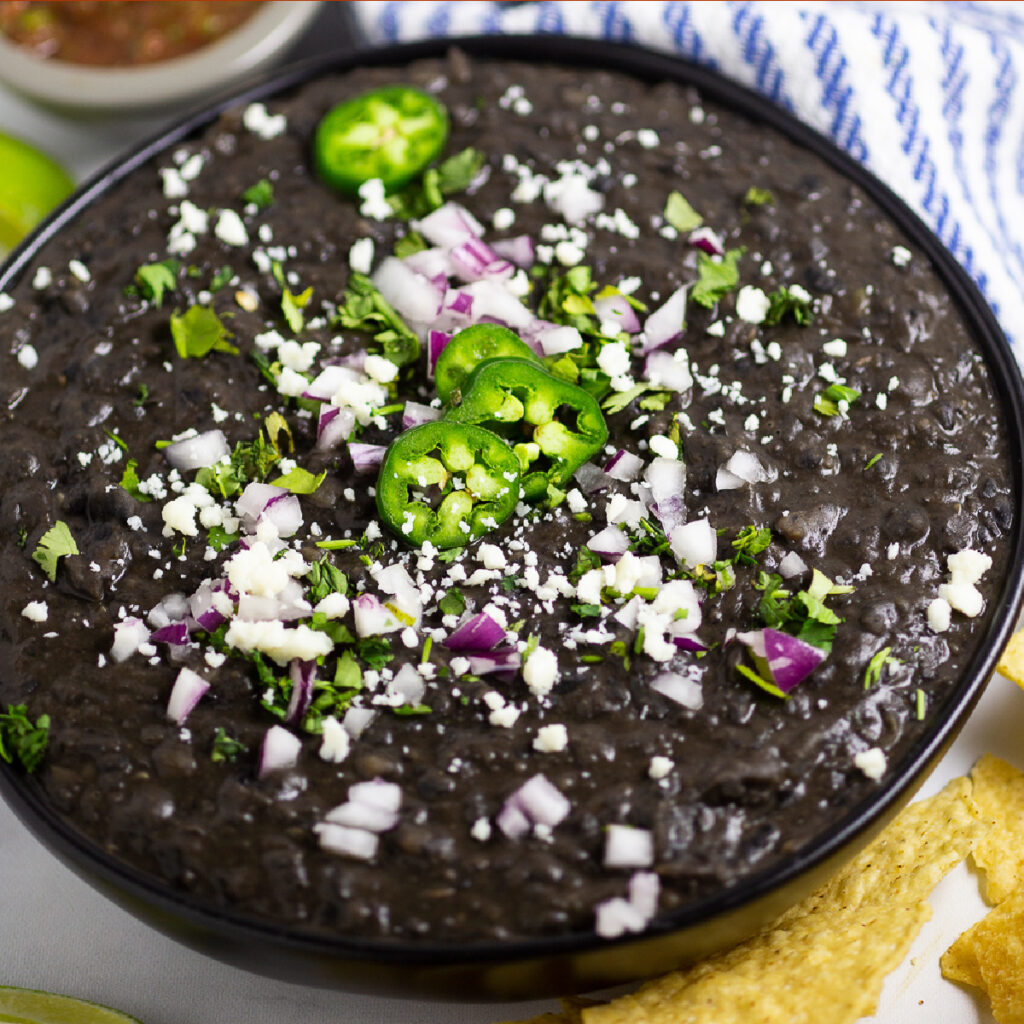 Homemade Refried Black Beans are not only healthy and vegan, but indescribably rich. Despite it's simple ingredients, this recipe packs big creamy flavor with a perfect smooth texture. Make them from canned beans or dried beans. Perfect for a Mexican side dish, tacos, burritos, or enchiladas.