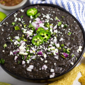 Homemade Refried Black Beans are not only healthy and vegan, but indescribably rich. Despite it's simple ingredients, this recipe packs big creamy flavor with a perfect smooth texture. Make them from canned beans or dried beans. Perfect for a Mexican side dish, tacos, burritos, or enchiladas.