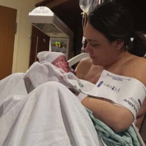 Picture of a mom in the hospital holding her newborn baby.