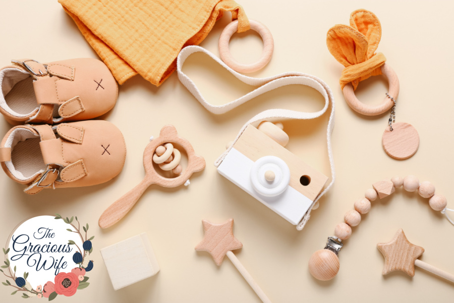 Wooden baby toys scattered around plain neutral surface