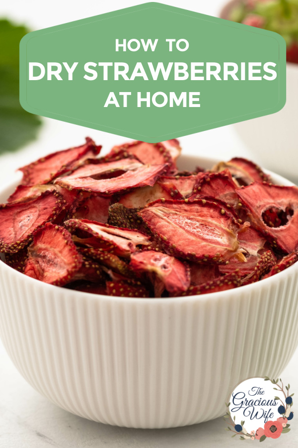 Bowl full of dried strawberries with the words "how to dry strawberries at home" at the top