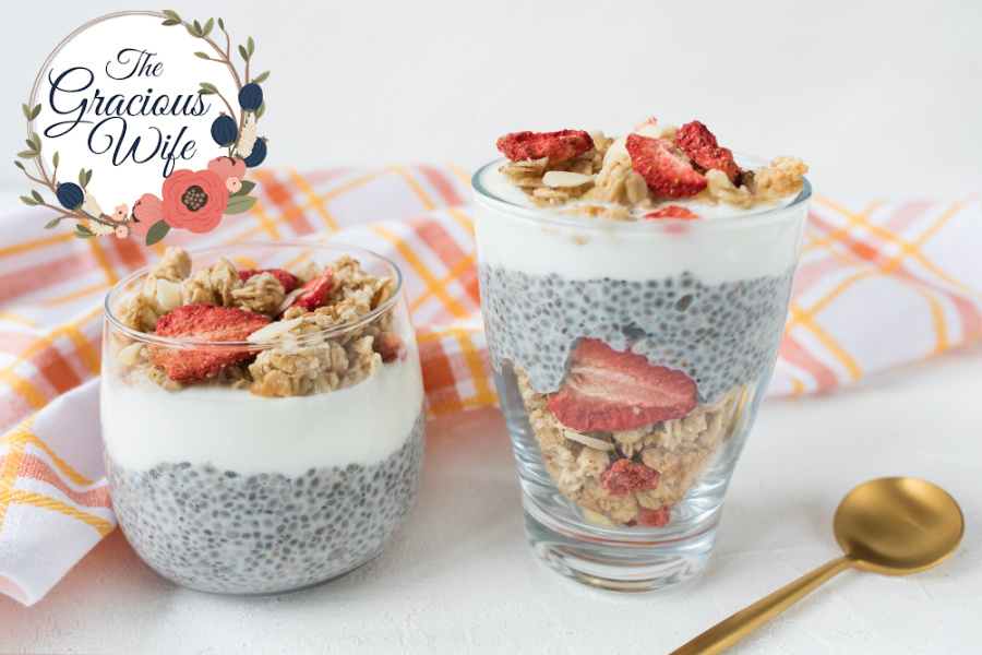 Chia pudding in a jar and a cup topped with granola and dried strawberries