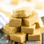 Stack of peanut butter fudge on a blue rustic wood background