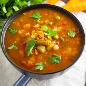 Homemade Vegetable Soup in a black bowl.