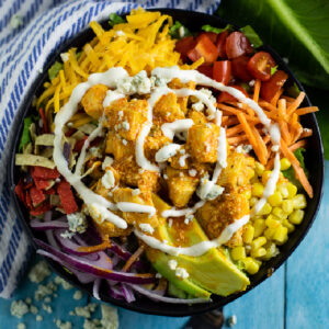 Fully loaded buffalo chicken salad with a swirl of ranch on top