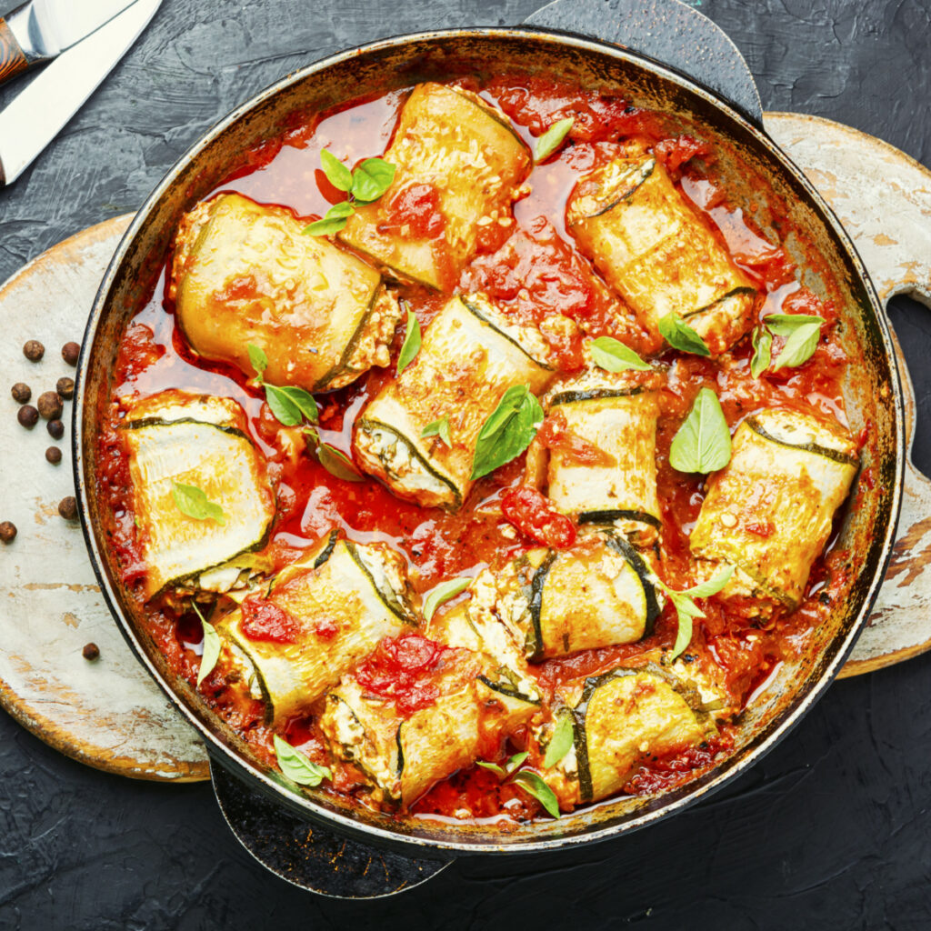 Zucchini rollatinis in a skillet with red sauce