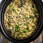 Slow Cooker Beef Stroganoff is so easy to make in the crockpot with tender beef and fresh mushrooms in a creamy herb sauce, served over warm egg noodles for a perfect comfort food family meal. A traditional recipe from scratch with sour cream that is truly the best you'll ever have!