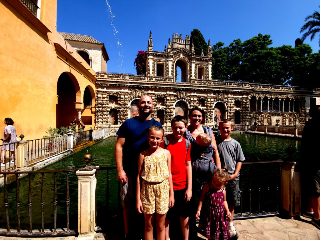 Family of seven in front of the castle and Mercury pond.