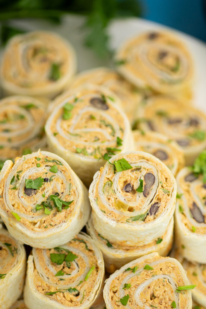 Close up of a stack of Mexican pinwheels topped with freshly chopped cilantro.