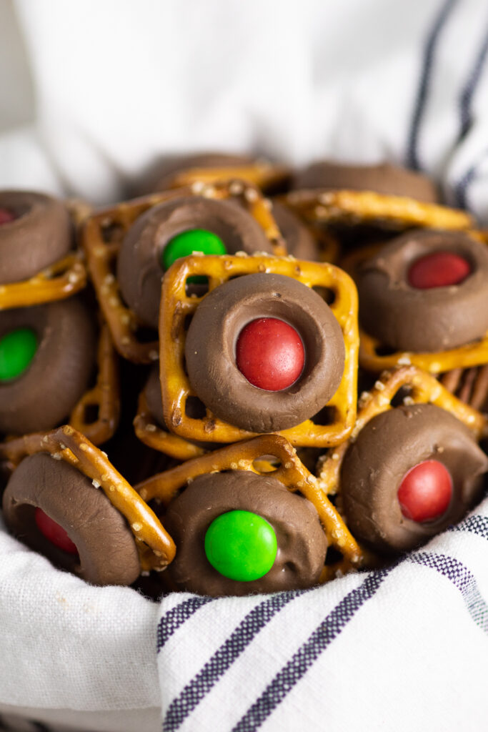 Rolo pretzels in a bowl lined with a linen napkin.