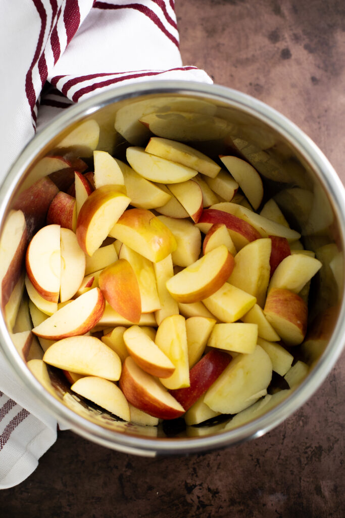 Apple slices in the instant pot getting ready to be made into applesauce.