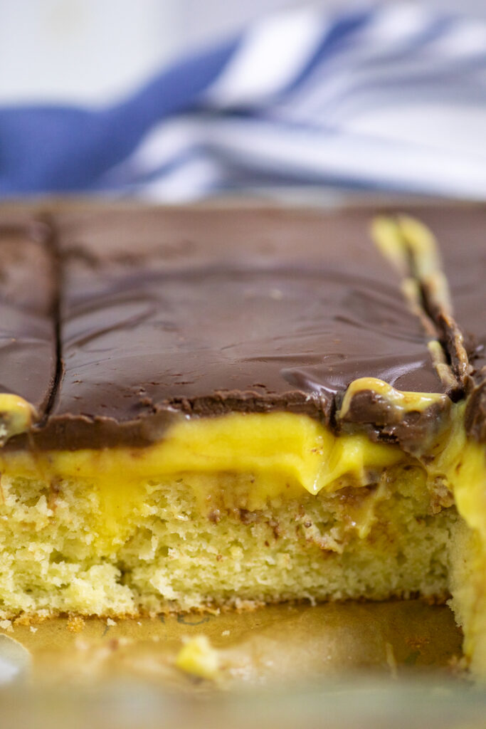Close up of the Boston cream poke cake still in the glass baking dish.